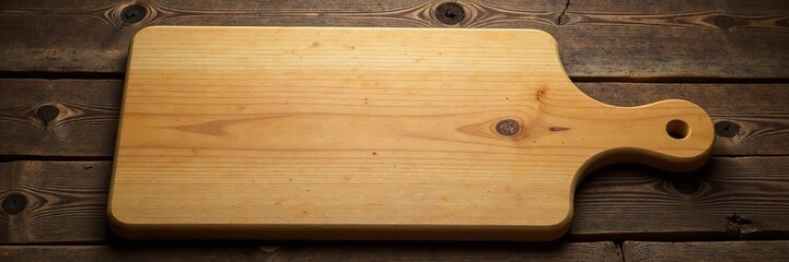 Fototapeta premium Cutting board made of light wood on a rustic wooden background, cooking, surface