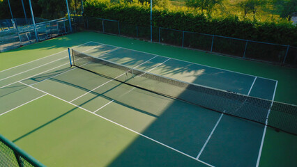 A simple tennis court with a net, ideal for sports and fitness scenes