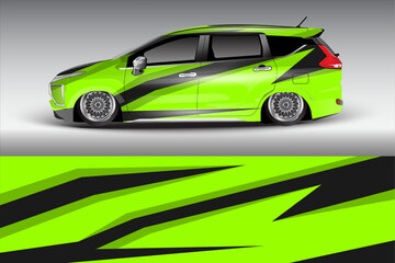 Sleek green car with dynamic black stripes parked in a minimalist studio setting showcasing modern design