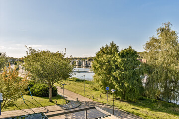 A beautiful park scene featuring lush trees and a serene lake, inviting relaxation and appreciation of nature's beauty. Perfect for outdoor activities or peaceful strolls.