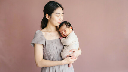 Fototapeta premium A woman cradling a baby in her arms, a moment of intimacy and love