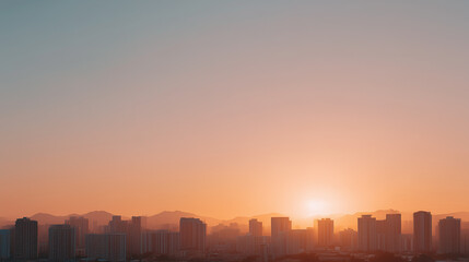 Fototapeta premium Warm golden sunset over modern city skyline with soft gradient sky and tranquil atmosphere