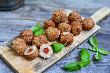 Mini  home made pork  oven baked meatballs with salsa filling.
 Party fingerfood. Diet  ketogenic food.