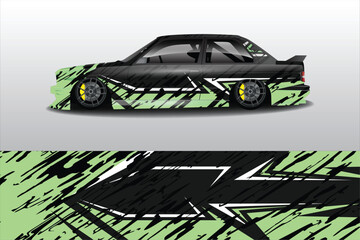 Sleek modified car with dynamic green and black design, showcasing its low profile and racing wheels