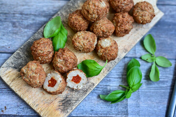 Mini  home made pork  oven baked meatballs with salsa filling.
 Party fingerfood. Diet  ketogenic food.