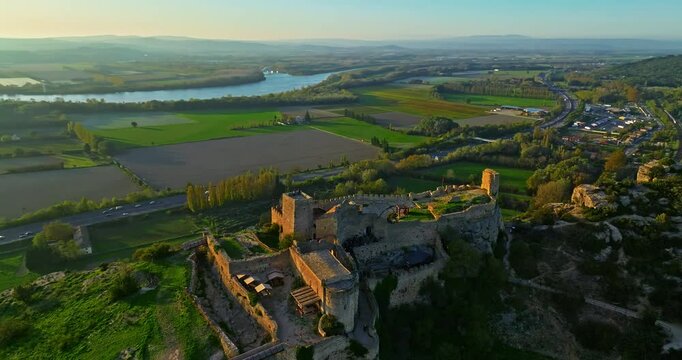 Mornas Fortress stands majestically on top of a rocky cliff. The Fortress of Mornas is a medieval fortress above the village of the same name in the French department of Vaucluse