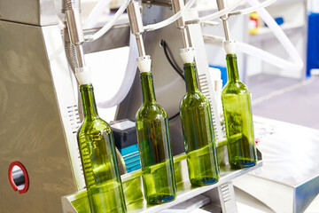 Bottles and gravity filling machine for beverages