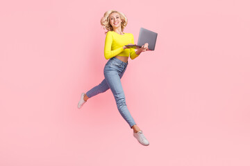 Full body photo of young girl wavy hair junior it program developer hold laptop jump wear yellow...