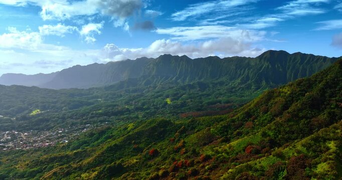 Bright sun lighting the stunning Koolau Range in the Oahu Island, Hawaii. Spectacular nature landscape with some urban area. Top view.