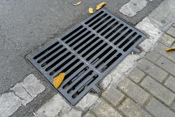 Fototapeta premium A gutter, a drain for rainwater on a pedestrian path