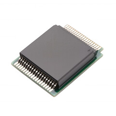 A close-up view of a microchip with a black casing on a green circuit board against a white background.