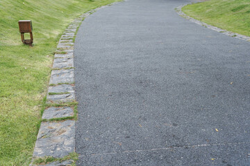 laying of sidewalks with new asphalt. Curbs enclosing the lawn, grass