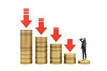 Businesswoman on coin stacks with red downward arrows, isolated on white background, symbolizing financial crisis and market collapse