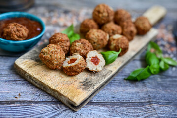 Mini  home made pork  oven baked meatballs with salsa filling.
 Party fingerfood. Diet  ketogenic food.
