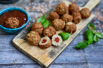 Mini  home made pork  oven baked meatballs with salsa filling.
 Party fingerfood. Diet  ketogenic food.