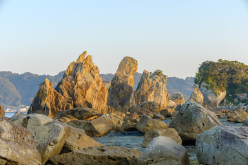 夕陽に照らされる橋杭岩の風景