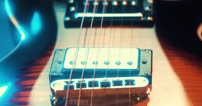 Close-Up of an Electric Guitar. Details of strings, frets, and the body shine under moody lighting. Music, creativity, and rock culture.
