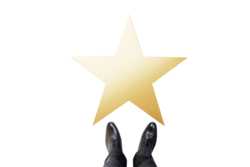 Golden star in front of businessperson's feet, isolated on white background, clean layout symbolizing achievement, opportunity, or recognition