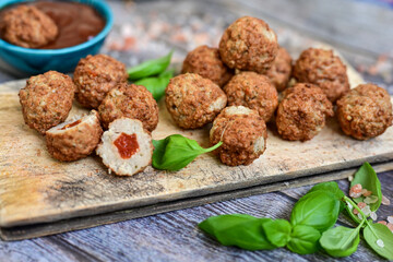 Mini  home made pork  oven baked meatballs with salsa filling.
 Party fingerfood. Diet  ketogenic food.