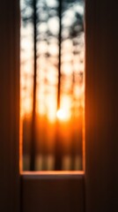 Fototapeta premium Warm sunlight streams through a narrow gap, illuminating a frame while tall trees stand in the background at dusk. The atmosphere is serene and tranquil, evoking calmness