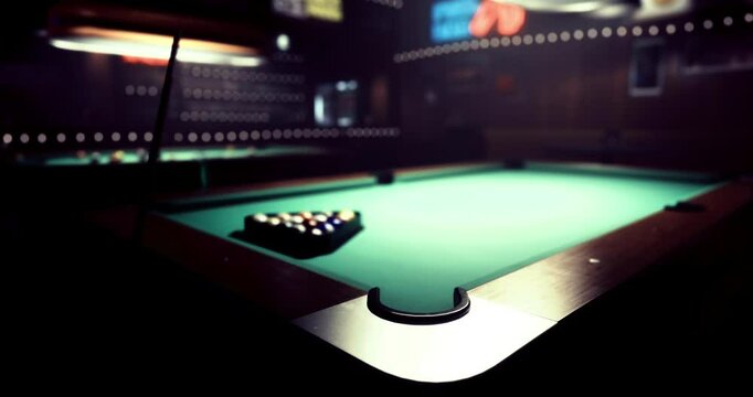A pool table with colorful balls arranged waits for players in a cozy bar. Soft lighting creates an inviting atmosphere for friends to gather and enjoy a game late into the night.