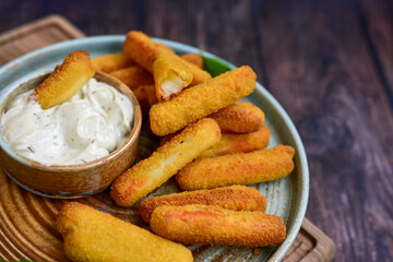  Mozzarella sticks .Italian cheese breaded  oven baked with  fresh basil on wooden background.Italian street food.
