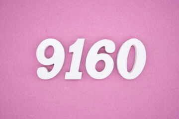 The numbers are made of white painted wood and placed on a pink paper background.