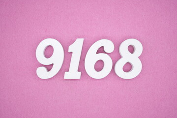 The numbers are made of white painted wood and placed on a pink paper background.