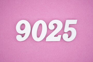 The numbers are made of white painted wood and placed on a pink paper background.