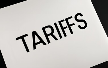 Tariffs word written on a white paper