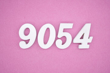 The numbers are made of white painted wood and placed on a pink paper background.