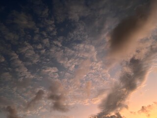 Beautiful sky with natural gradations. Thick clouds in the dusk sky on a winter night. Image of a cloudy sky in the afternoon. View of the night sky with golden light from the evening sun