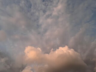 Beautiful sky with natural gradations. Thick clouds in the dusk sky on a winter night. Image of a cloudy sky in the afternoon. View of the night sky with golden light from the evening sun