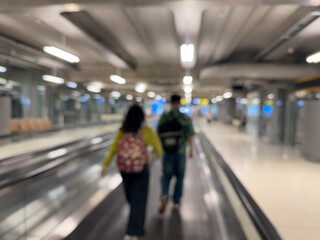 Blurred Airport Walkway with Travelers