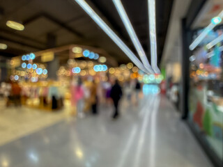 blurred image of a bustling shopping mall, capturing the vibrant atmosphere of a modern retail environment.