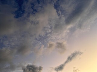 Beautiful sky with natural gradations. Thick clouds in the dusk sky on a winter night. Image of a cloudy sky in the afternoon. View of the night sky with golden light from the evening sun