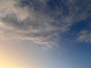 Beautiful sky with natural gradations. Thick clouds in the dusk sky on a winter night. Image of a cloudy sky in the afternoon. View of the night sky with golden light from the evening sun