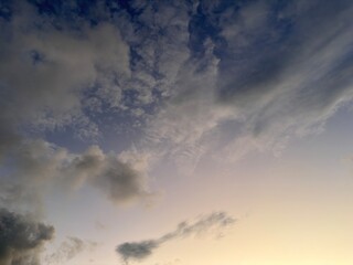 Beautiful sky with natural gradations. Thick clouds in the dusk sky on a winter night. Image of a cloudy sky in the afternoon. View of the night sky with golden light from the evening sun