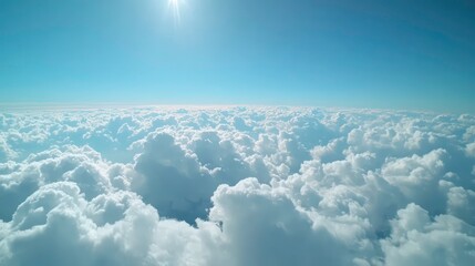 Airplane window view shows vast blue sky dotted with white fluffy clouds. Travelers see beautiful landscape from airplane. Travel photo ideal for tourism websites, travel agencies. Window