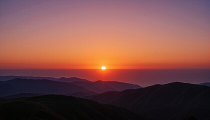Fototapeta premium Serene sunset over tranquil mountains and ocean horizon 