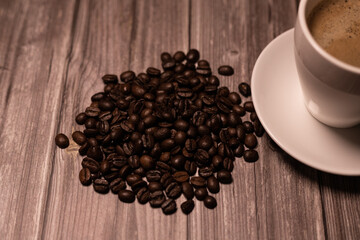 Roasted coffee beans on a wooden table. Arabica beans