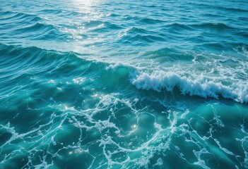 A powerful wave crashes onto the sandy shore, sending white foam spraying into the air. The deep blue ocean glistens under the sunlight, creating a serene yet dynamic scene.