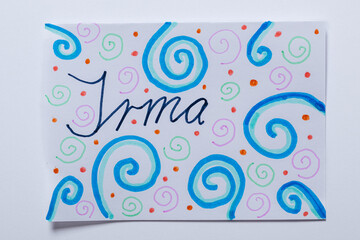 Handcrafted greeting card with “Irma” written in artistic calligraphy and colorful swirls.