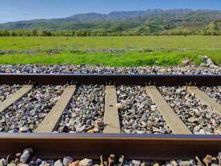 train track, green valley and mountains