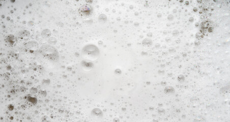 White soapy foam bubbles texture background, top view