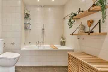 Featuring sleek lines and natural elements, this minimalist bathroom incorporates wood accents and plants for a serene atmosphere.