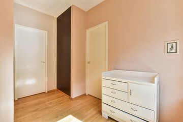 This spacious room features soft pastel walls and simple furniture, creating a calming atmosphere perfect for relaxation or productivity.