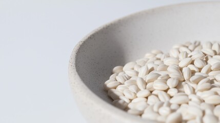 White short grain rice in ceramic bowl on minimal light background
