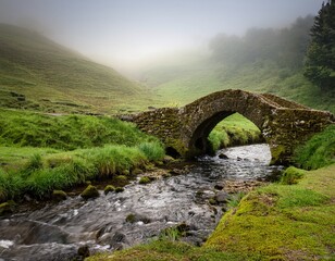 a moss covered stone bridge gracefully arches over a serene stream framed by misty verdant hills evoking a timeless connection with nature