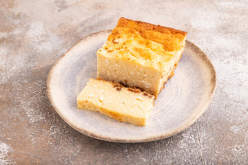 Сottage cheese Сasserole, Curd cake, with dried apricots and raisins on brown concrete, side view, close up
